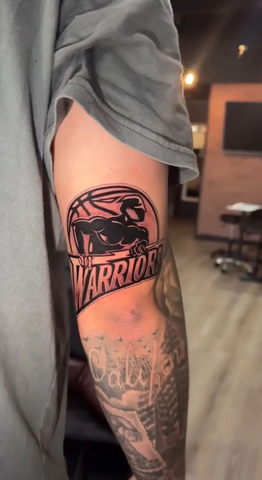 Warriors logo and San Francisco lettering leg tattoo